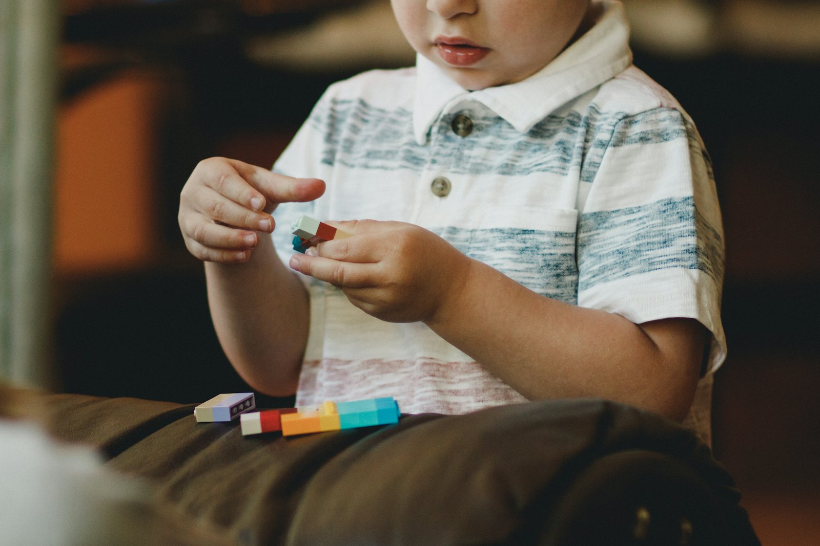A child's hands playing with building pieces