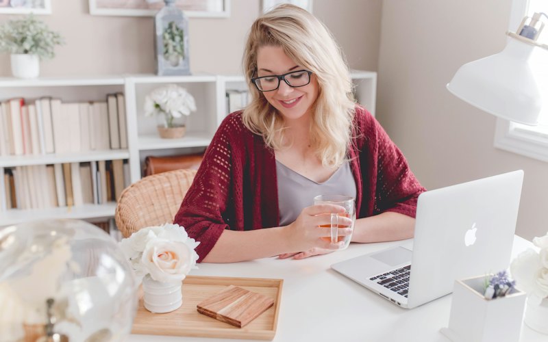 A childcare director working on a laptop