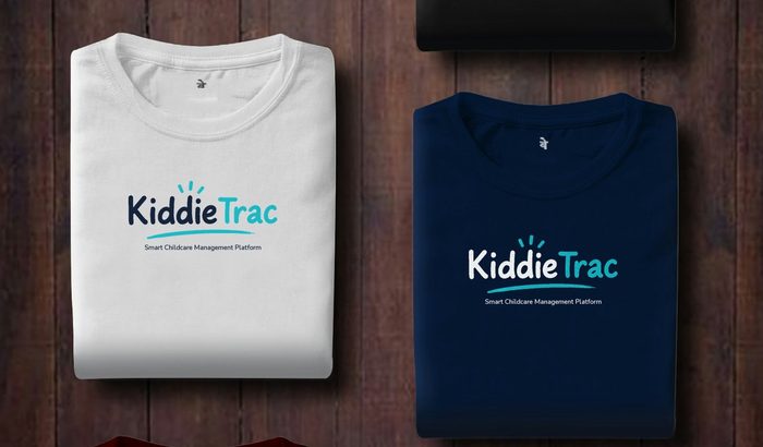 Folded white and navy KiddieTrac t-shirts